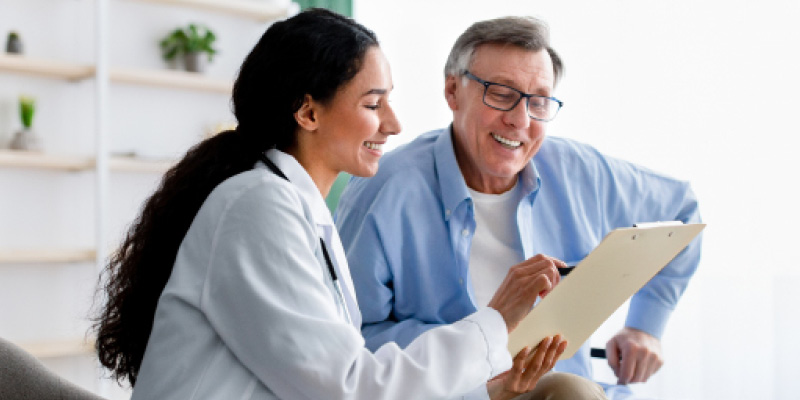 Doctor reviewing a medical form with an older man
